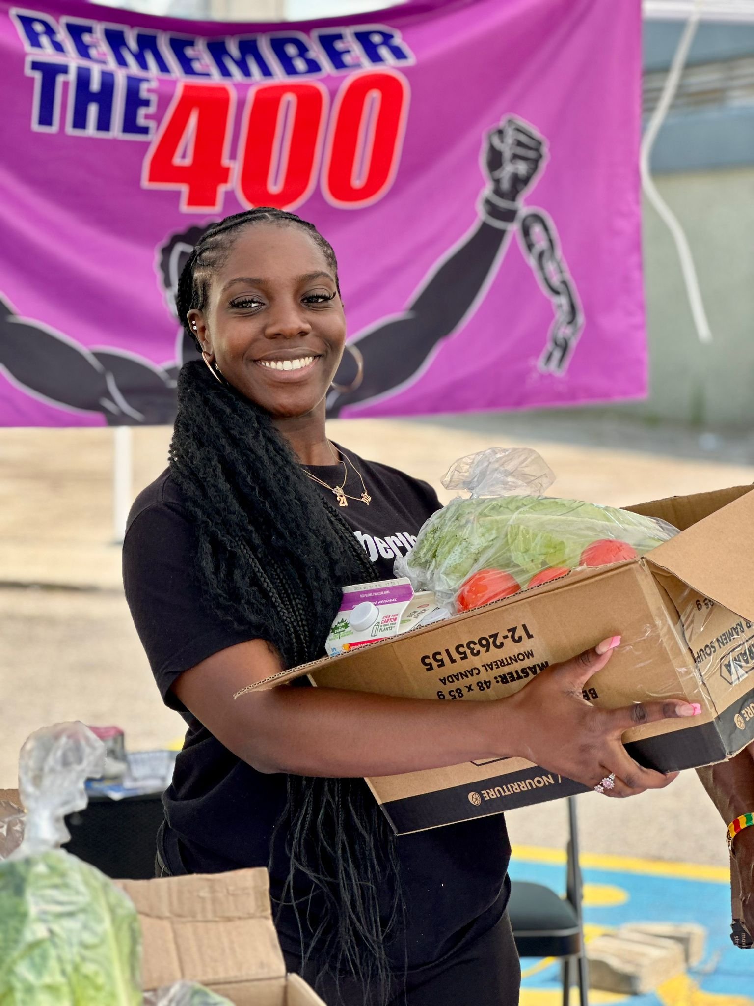 Volunteer holding fresh food at a community giveaway