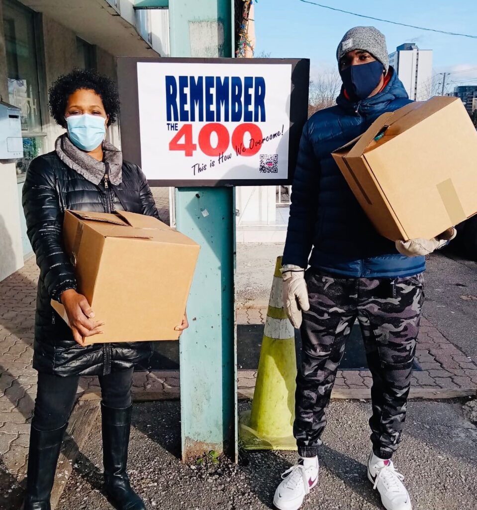 Remember The 400 volunteers carrying food boxes at a community distribution
